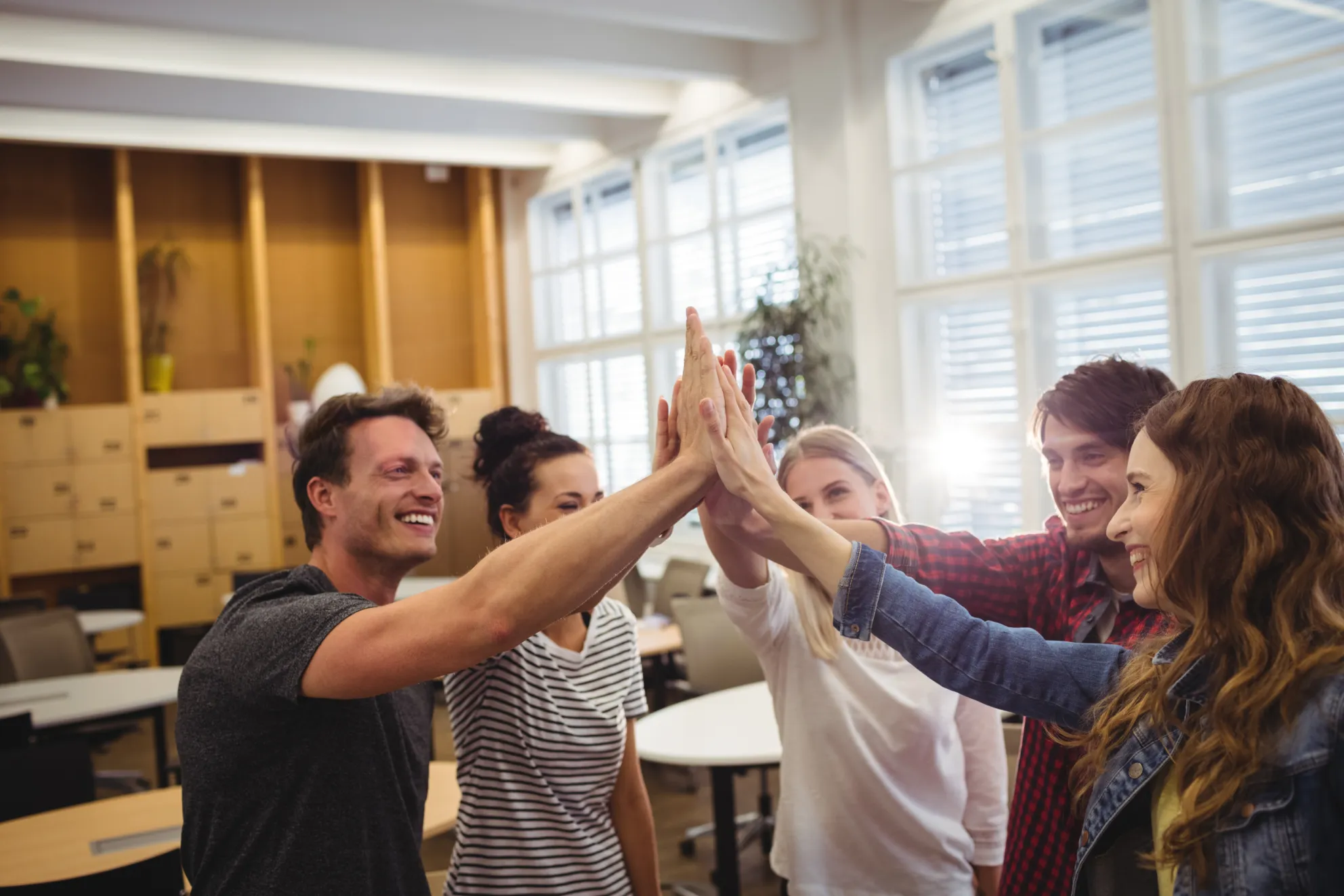 Group of business executives giving high five